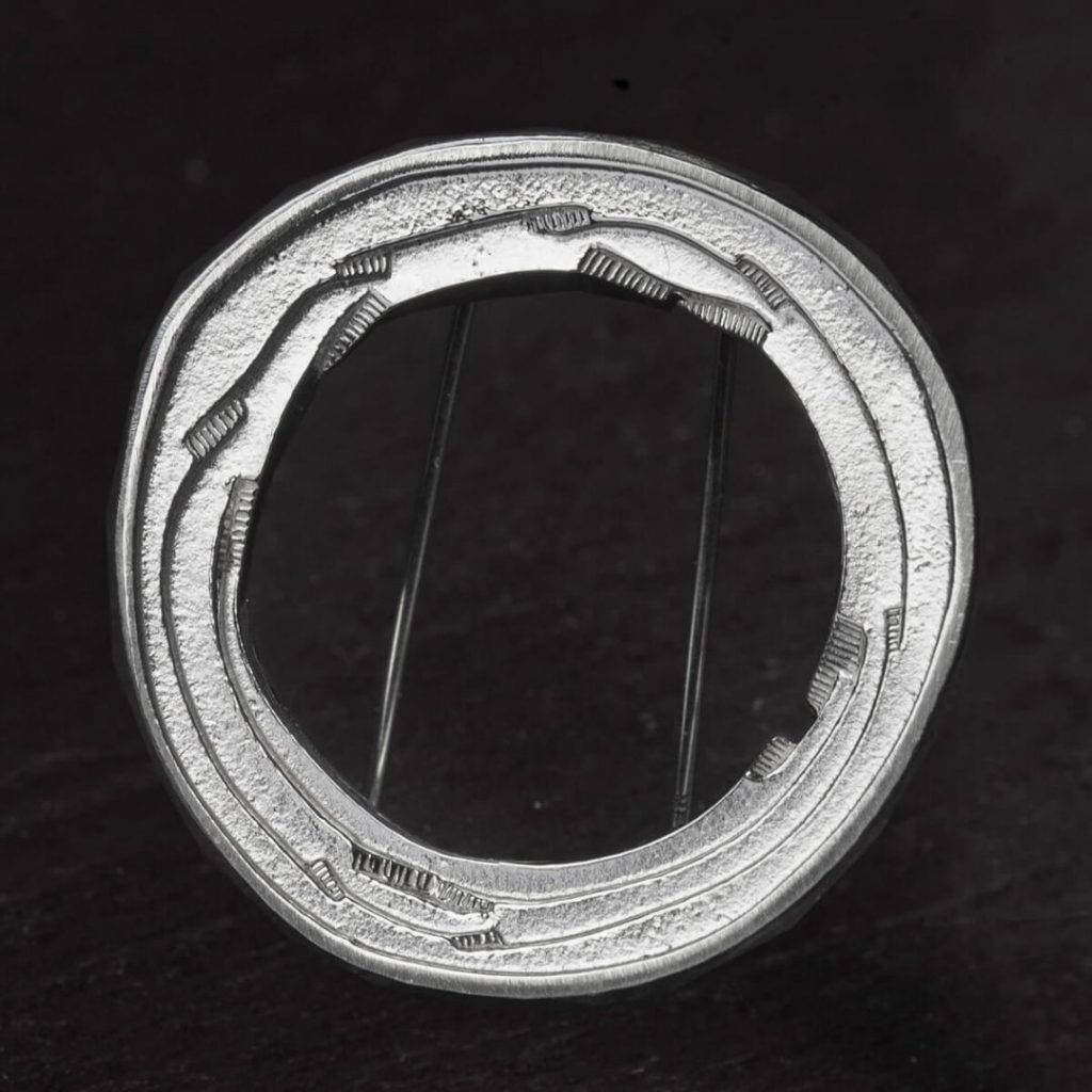 Grianán of Aileach silver brooch on black background