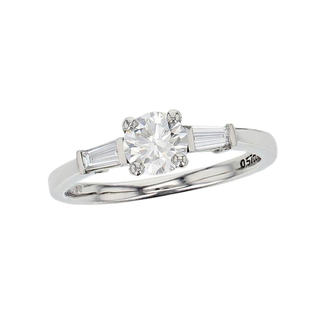 round cut diamond trilogy engagement ring, tapered baguette side diamonds, platinum designer handmade by Faller, hand crafted, betrothal, promise, precious jewellery, jewelry, GIA certified, hand crafted, G.I.A. GIA, three stone