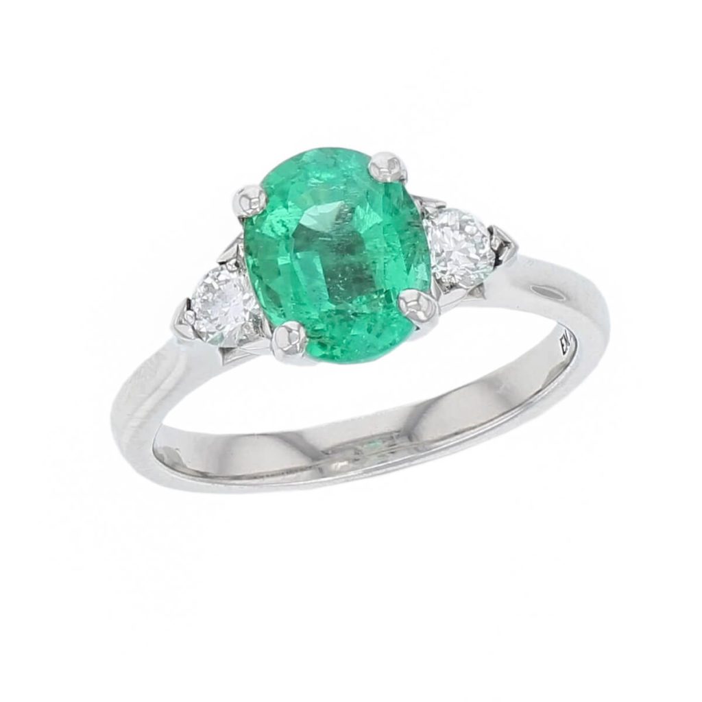 alternative engagement ring, platinum ladies oval cut emerald & diamond designer trilogy ring designed & hand crafted by Faller of Derry/ Londonderry, dress ring, precious green gem jewellery, jewelry
