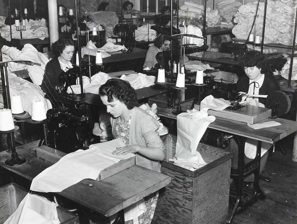 Black & white photo of the City Shirt Factory women sticthing shirts